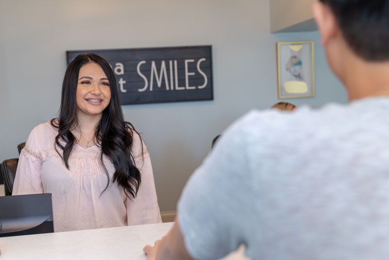 Staff greet patient front desk